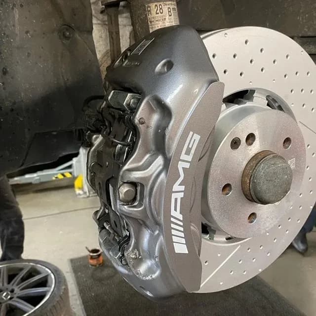Mercedes-AMG wheel, brake disc and red caliper at Benza Autos