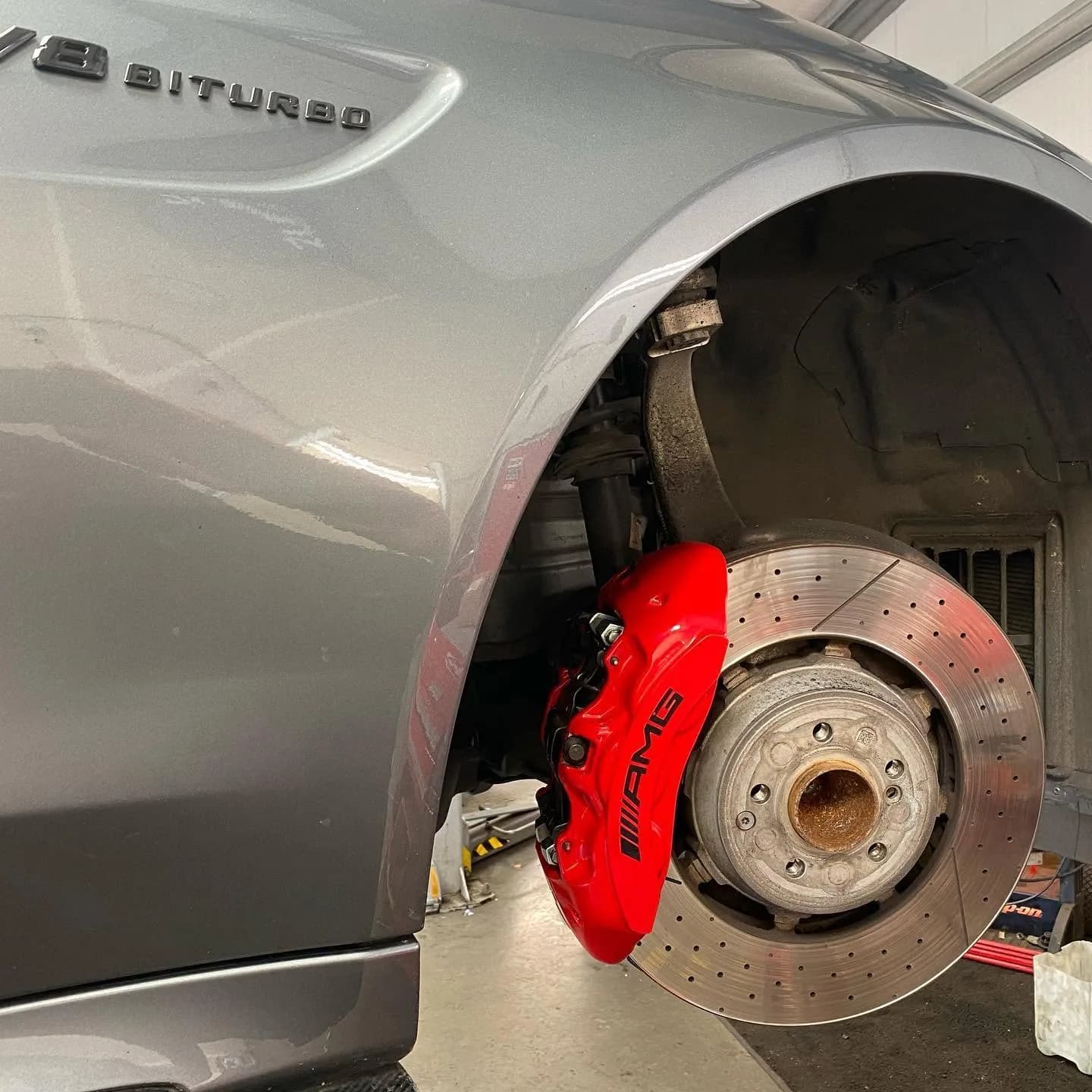Mercedes-AMG brake disc and red caliper at Benza Autos